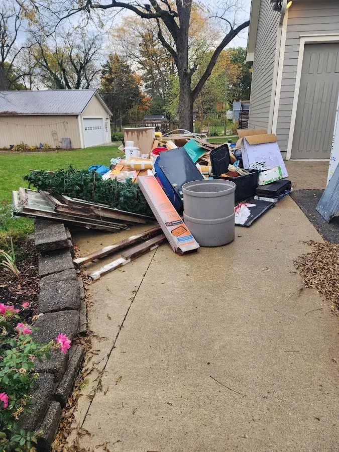 Dumpster being loaded with debris for Estate Cleanout Dumpster Rental in Hornellsville